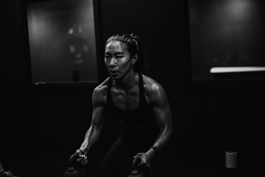 Female athlete doing a kettlebell workout.